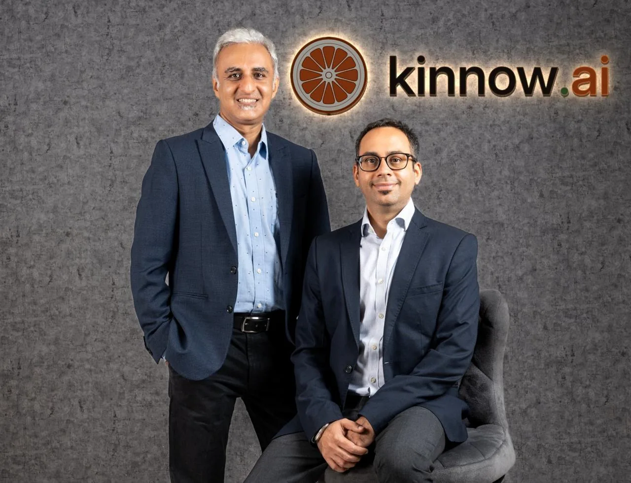 Ashish Chawla and Tejas Vyas, the co-founders of Kinnow, in front of the Kinnow sign